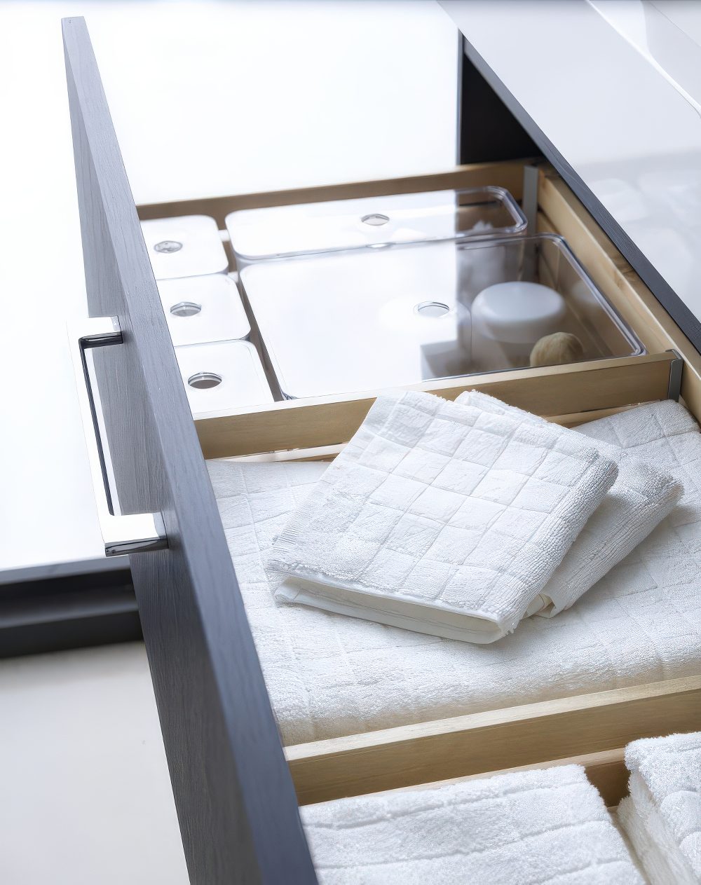 A drawer in the vanity will save much space and hold everything you need, from towels to makeup.