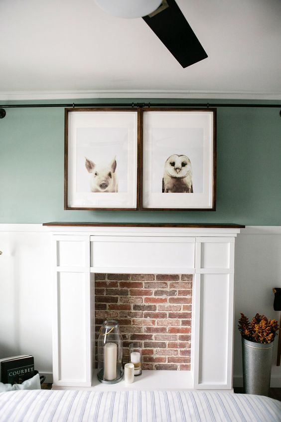 A faux fireplace, a TV hidden with artworks that can be moved to watch the TV is a very cool idea.