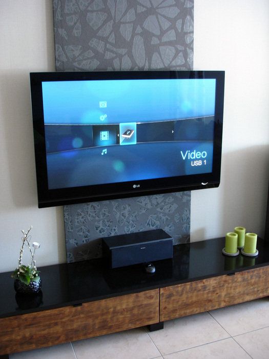 A fabric panel on the wall accents the TV and media console and hides all the cables away giving a sleek and decluttered look to the space.