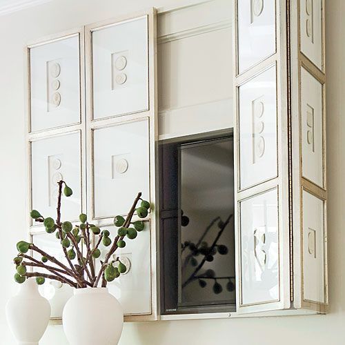 A TV hidden with bi-fold art panels that form a gallery wall is a lovely idea for any space.