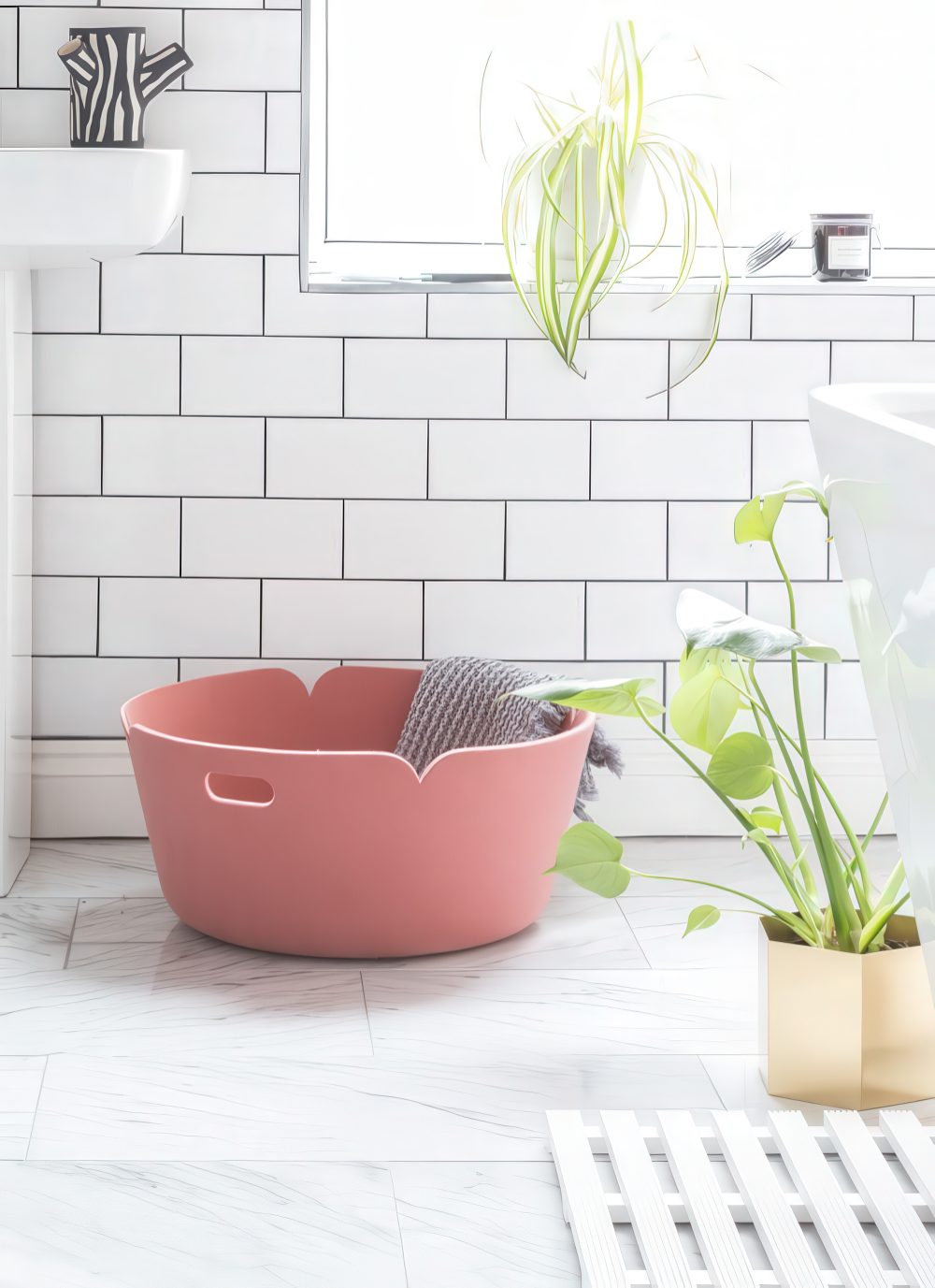 A pink felt laundry basket like this one can store a lot of towels and it looks pretty and cool.