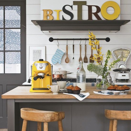 A sunny yellow coffee machine and a matching sign to cheer up the space.