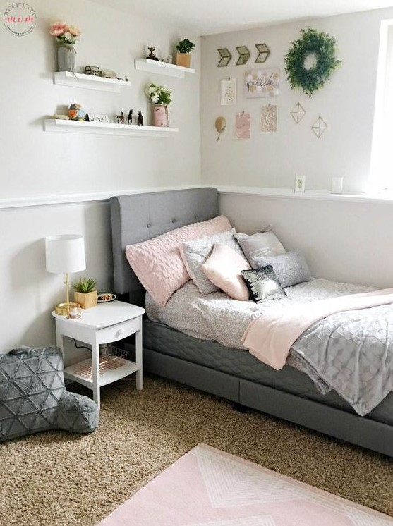 A contemporary teen room with a grey upholstered bed, layered rugs, soft pillows and a gallery wall.