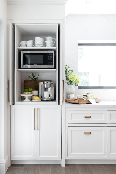 A small cabinet with mugs, jugs and cups, a mini coffee station with fruits and cookies and a microwave is a cool idea.