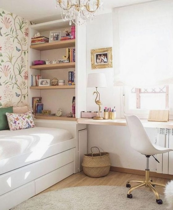 An airy teen girl bedroom with flroal wallpaper, a crystal chandelier, hot pink and gold touches is lovely.