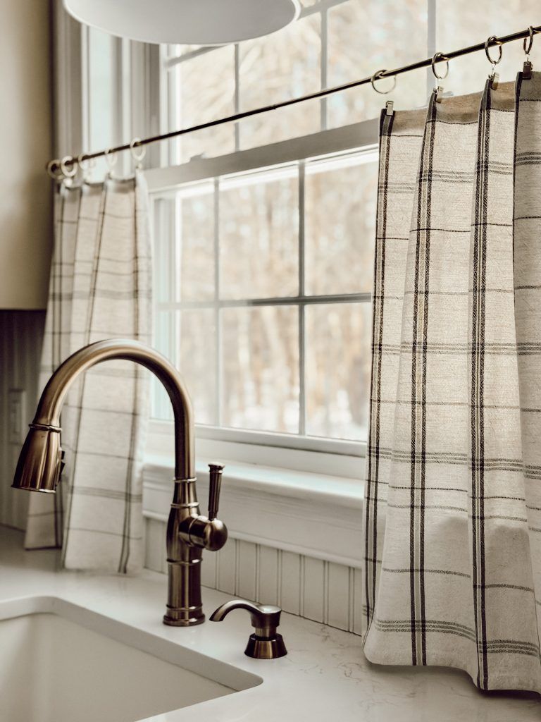 Plaid cafe curtains are great to block the unwanted view but enjoy the light.