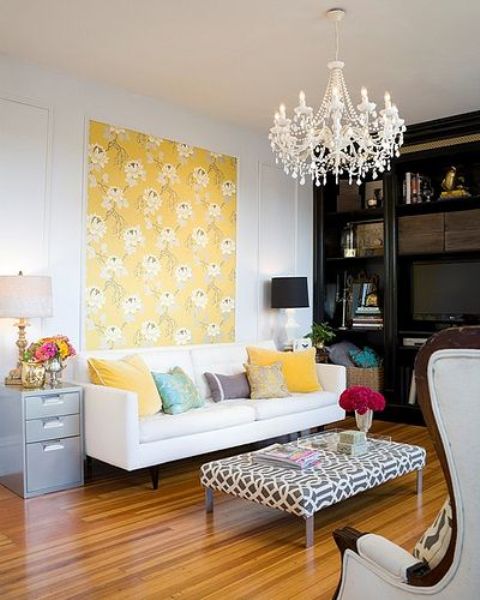 Bold pillows, a floral artwork, some blooms in vases for a bright feel in the living room.