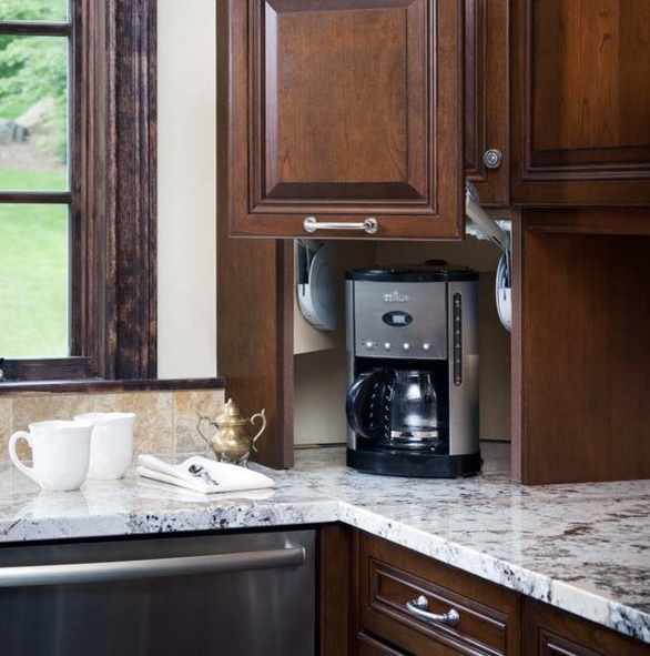 A dark stained cabinet with a sliding door and a coffee machine there is a lovely idea to hide everything you don't need right now.