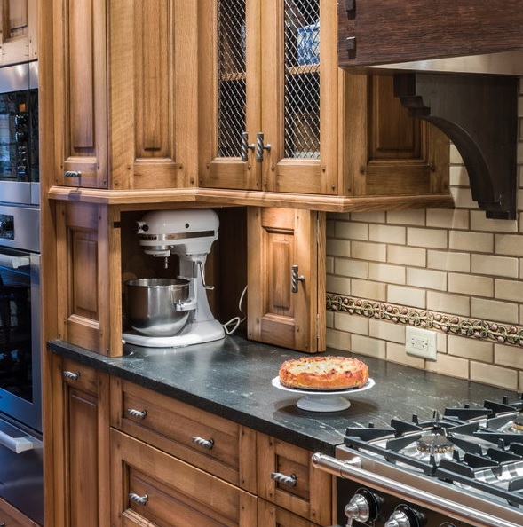 Part of countertop turned into a cabinet with a floding door and hiding a mixer is a lovely and cool idea to keep the space decluttered.