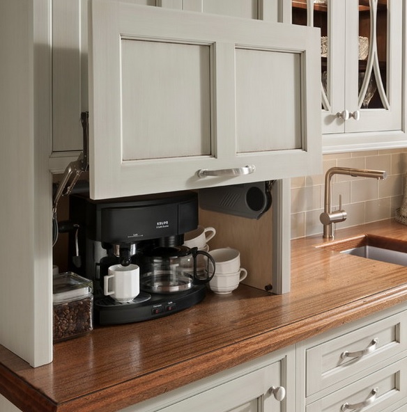 A storage cabinet with a retractable door and a mini coffee station inside, with coffee and a coffee machine.