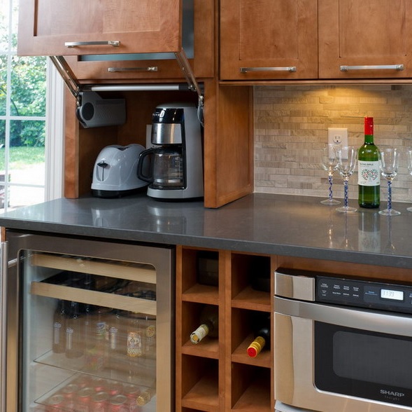 A mni cabinet with a retracting door and a couple of appliances inside is a creative idea for storage.