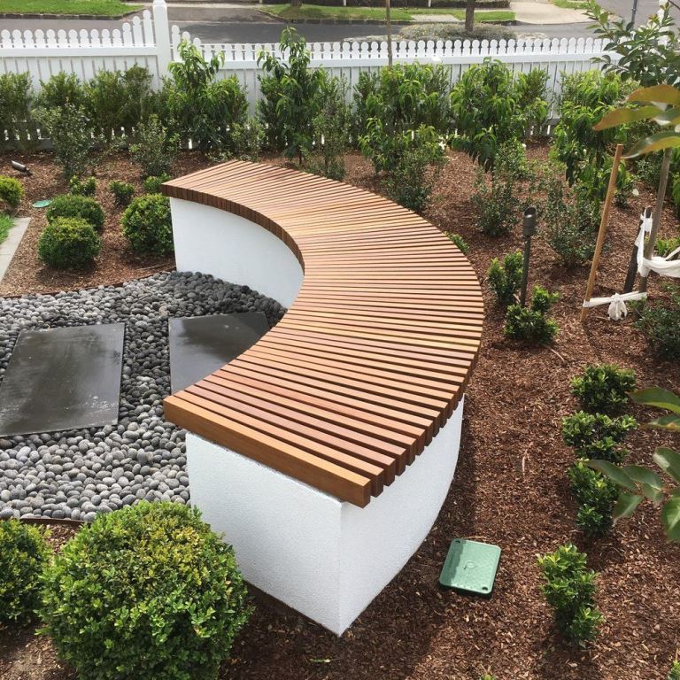 This curved storage bench is functional idea: you get a trendy piece and storage space in one.