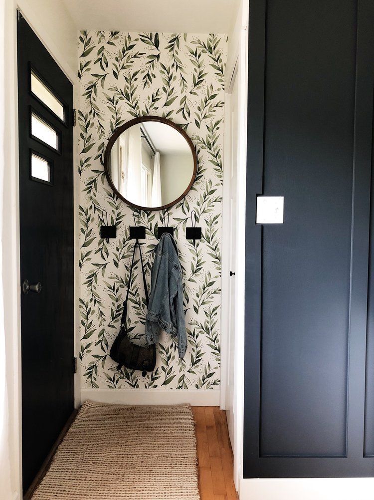 Here hooks are attached to the wall right behind the door taking this small piece of space.