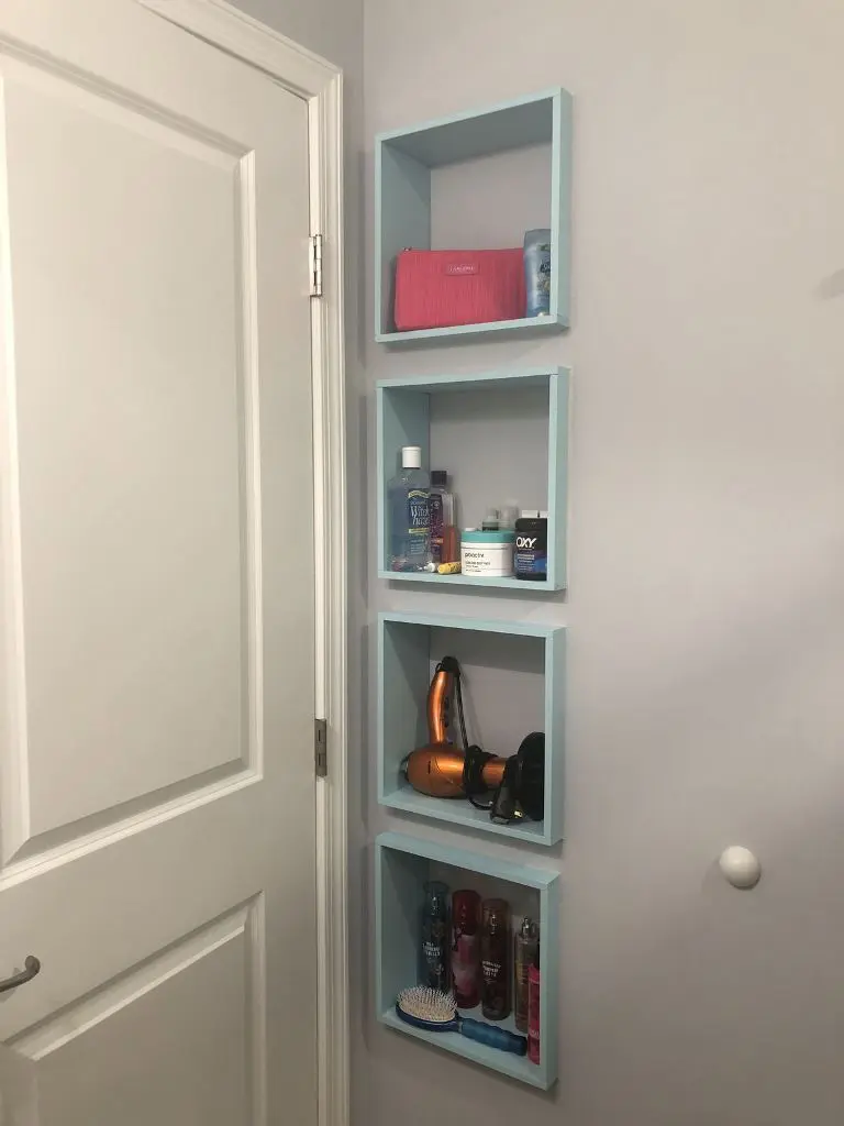 Small niches are finished with blue frames and they are used for storing everything.
