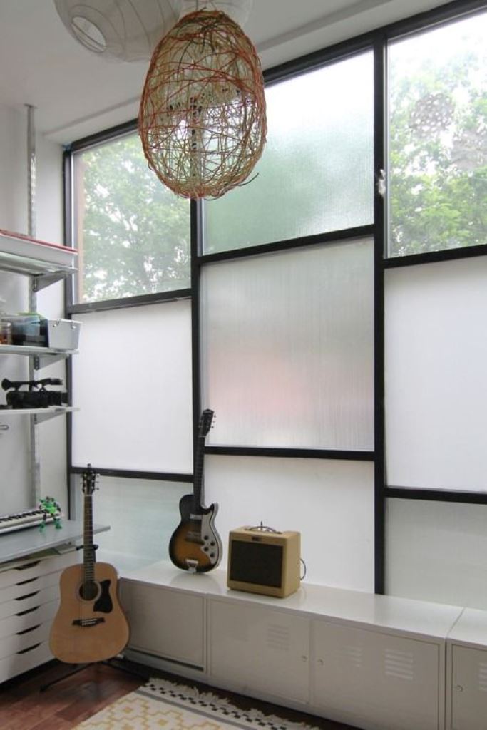This window is done with film and rain glass to block the unwanted view and still have enough light. 

(via moonwoods).