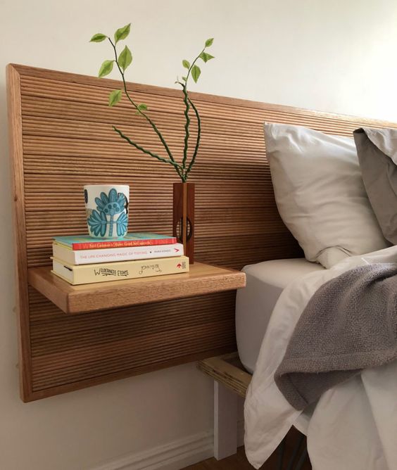 This framed ribbed headboard with attached nightstands can be added to your bedroom to increase functionality and add texture.