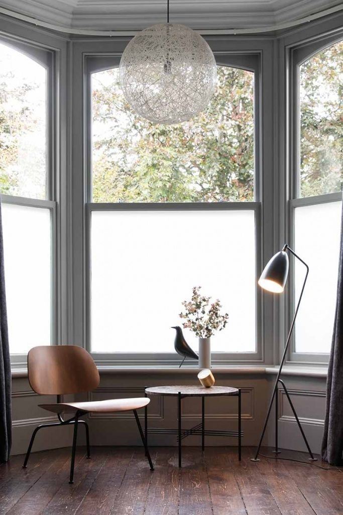 This beautiful bow window is covered with white film to keep the nook private and dark curtains are added on the sides.