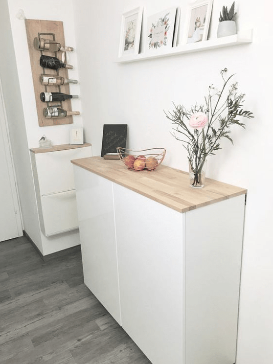 A floating sideboard of an IKEA Metod cabinet and a matching hack for an IKEA Trones piece are a great combo for a Scandinavian entryway.