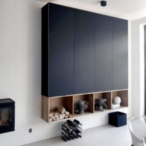 A large black storage unit built of several IKEA Metod cabinets and some open storage boxes underneath looks very contemporary.